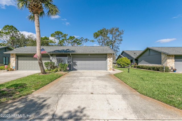 view of front facade featuring a garage, stone siding, a front lawn, and driveway