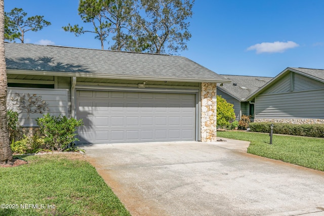 view of front of house with stone siding, a front lawn, concrete driveway, and roof with shingles