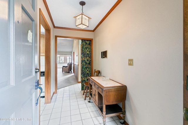 foyer featuring ornamental molding, light tile patterned flooring, and baseboards