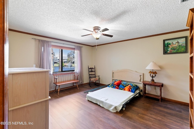 bedroom featuring ornamental molding, dark wood-type flooring, and a textured ceiling