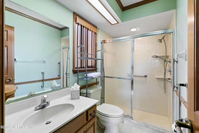 full bathroom with toilet, a stall shower, vanity, and crown molding