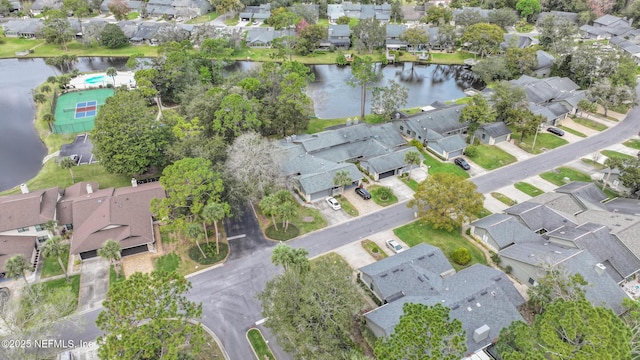 drone / aerial view with a water view and a residential view