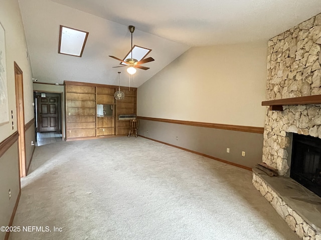 195 Deer Lake Cir, Ormond Beach, FL 32174 - unfurnished living room featuring a skylight, carpet, vaulted ceiling, a fireplace, and a ceiling fan