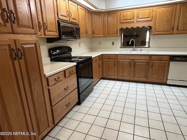 195 Deer Lake Cir, Ormond Beach, FL 32174 - kitchen with black appliances, a sink, light countertops, light tile patterned floors, and brown cabinetry