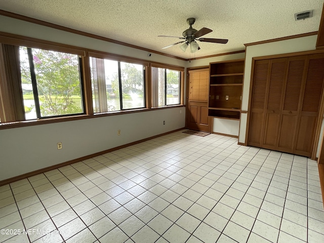 195 Deer Lake Cir, Ormond Beach, FL 32174 - unfurnished bedroom featuring ornamental molding, a textured ceiling, light tile patterned floors, baseboards, and a closet