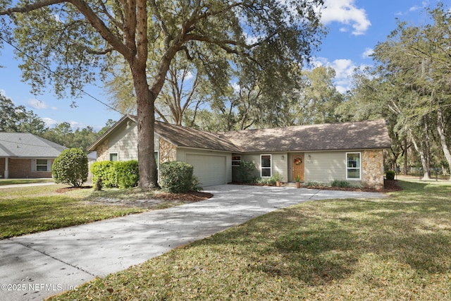 view of front facade with a front lawn, concrete driveway, and an attached garage