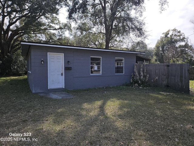 view of outbuilding featuring a lawn