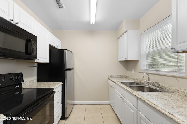 kitchen featuring sink, black appliances, white cabinets, and light tile patterned flooring