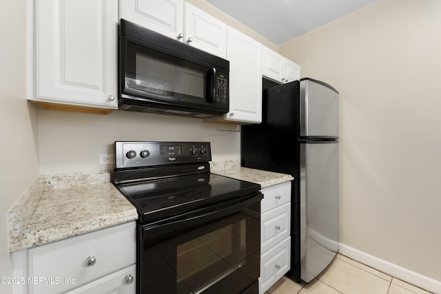 kitchen with light tile patterned floors, white cabinets, and black appliances