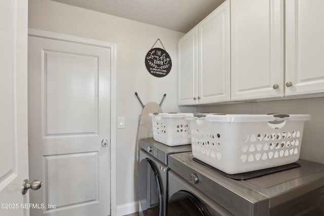 laundry room featuring separate washer and dryer and cabinets