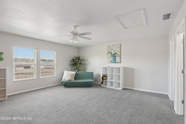 unfurnished room with ceiling fan, carpet flooring, and a textured ceiling