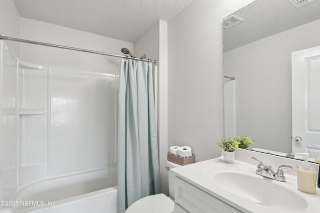 full bathroom with vanity, shower / tub combo, toilet, and a textured ceiling