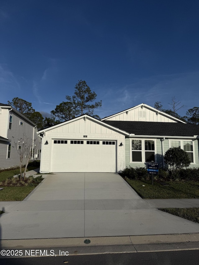 view of front facade with a garage, board and batten siding, and concrete driveway