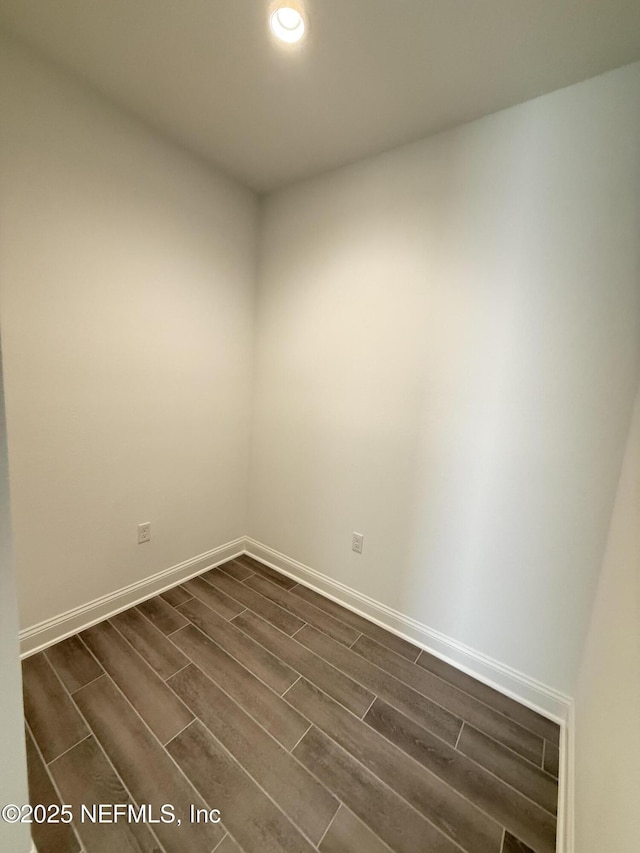 empty room with recessed lighting, baseboards, and wood finish floors