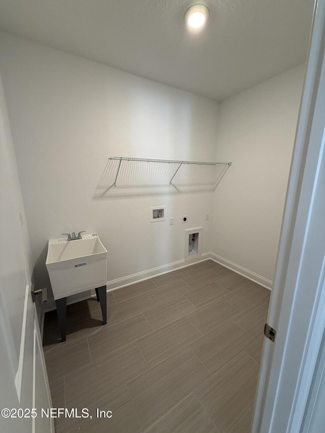 clothes washing area with baseboards, laundry area, washer hookup, and hookup for an electric dryer