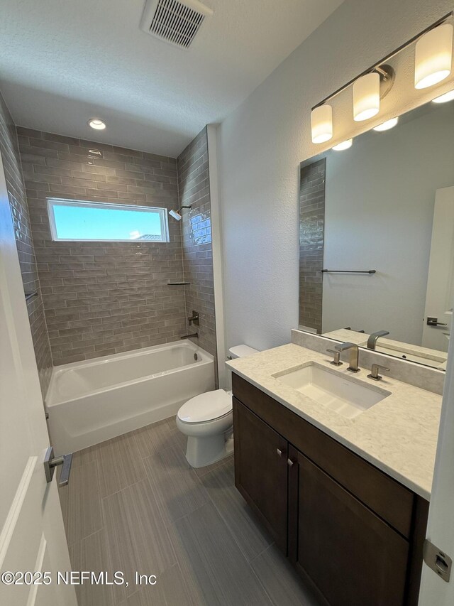 bathroom with toilet, vanity, bathtub / shower combination, and visible vents