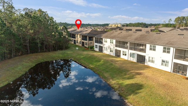 birds eye view of property with a water view