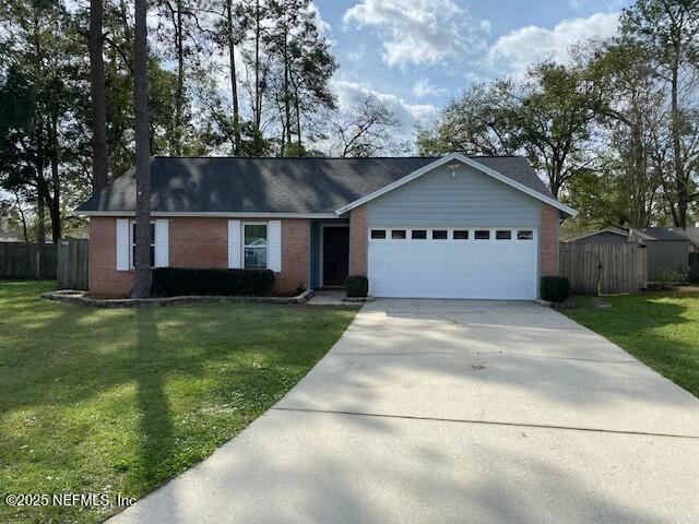 ranch-style home featuring a garage and a front lawn