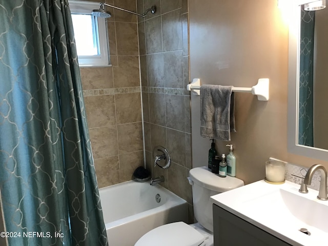 full bathroom with vanity, shower / bath combination with curtain, and toilet