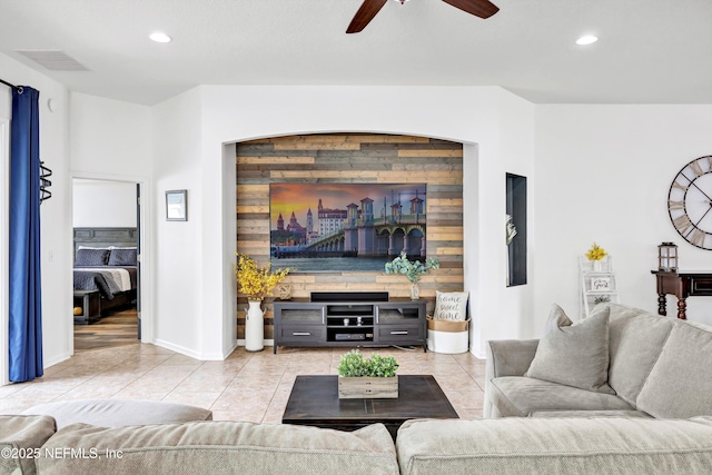 tiled living room featuring ceiling fan