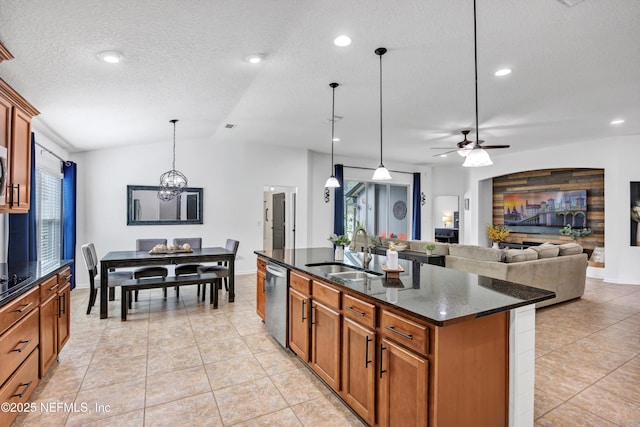 kitchen with sink, dark stone countertops, hanging light fixtures, a kitchen island with sink, and stainless steel dishwasher