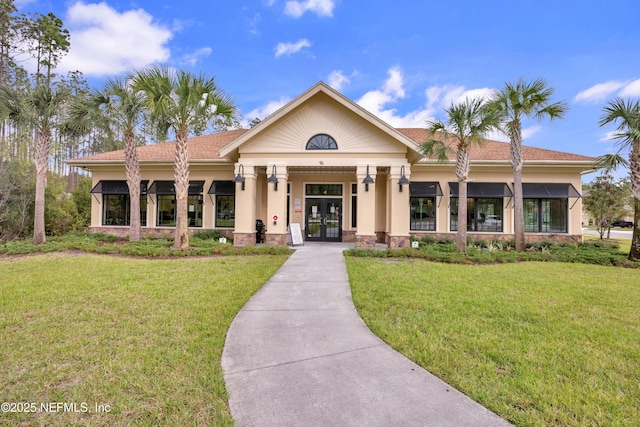 view of front of property with a front lawn and french doors