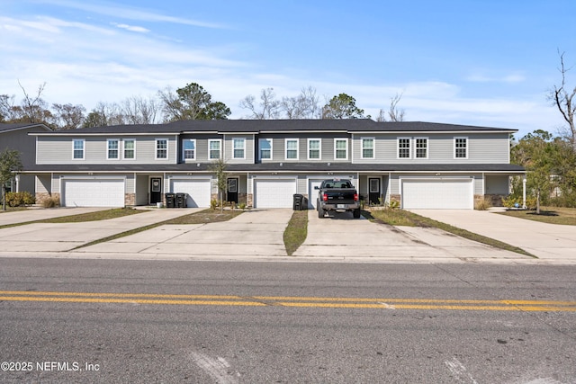 view of property with driveway and an attached garage