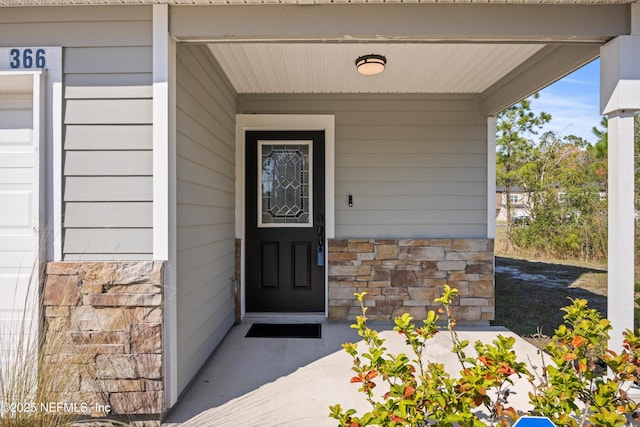 entrance to property with stone siding