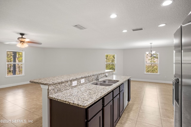 kitchen with light tile patterned floors, visible vents, a sink, and stainless steel fridge with ice dispenser