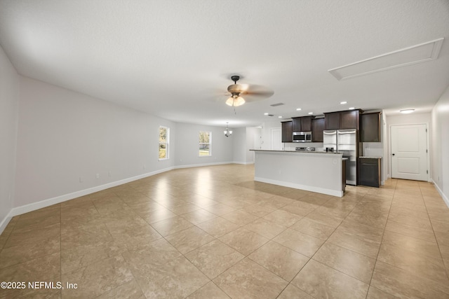 unfurnished living room with recessed lighting, light tile patterned floors, baseboards, and ceiling fan with notable chandelier