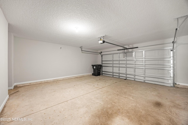 garage with a garage door opener and baseboards