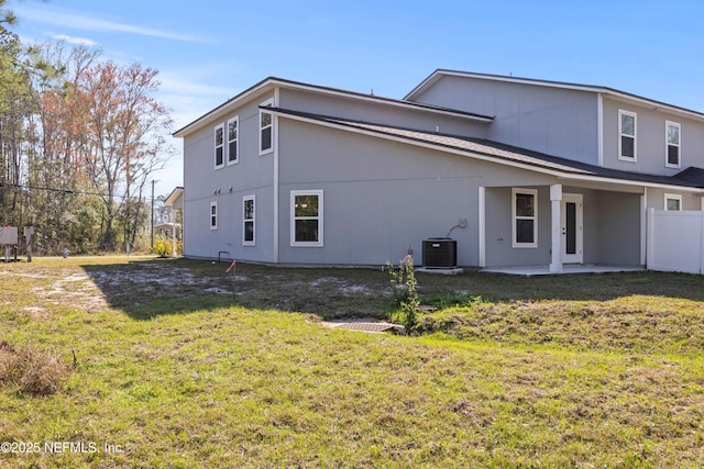 rear view of property with a patio area, a yard, fence, and central air condition unit