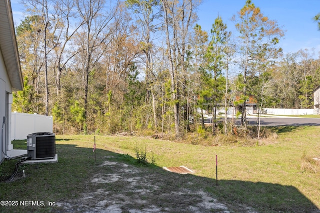 view of yard with cooling unit and fence