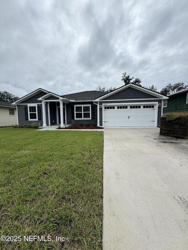 single story home featuring a garage and a front yard