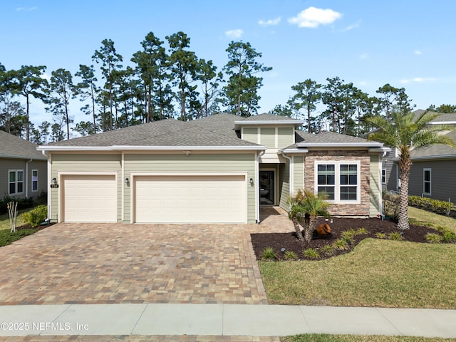 view of front of home featuring a front yard and a garage