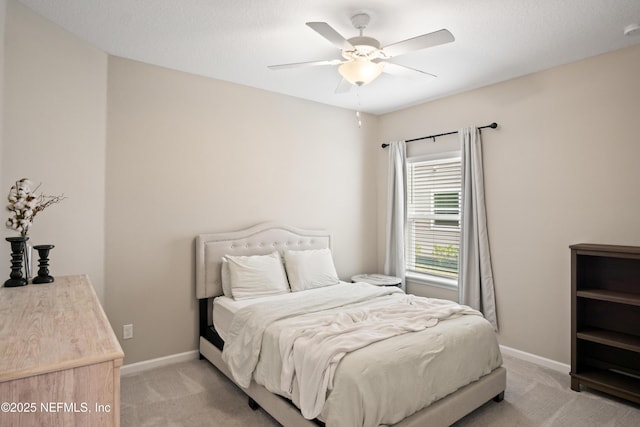 bedroom featuring ceiling fan and light carpet