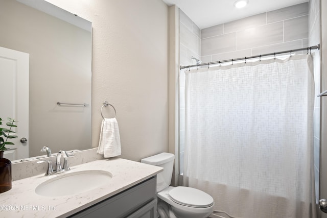 full bathroom featuring shower / tub combo, toilet, and vanity