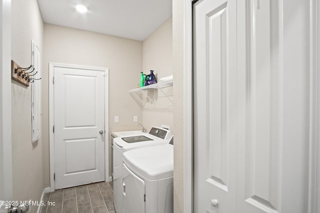 clothes washing area featuring separate washer and dryer