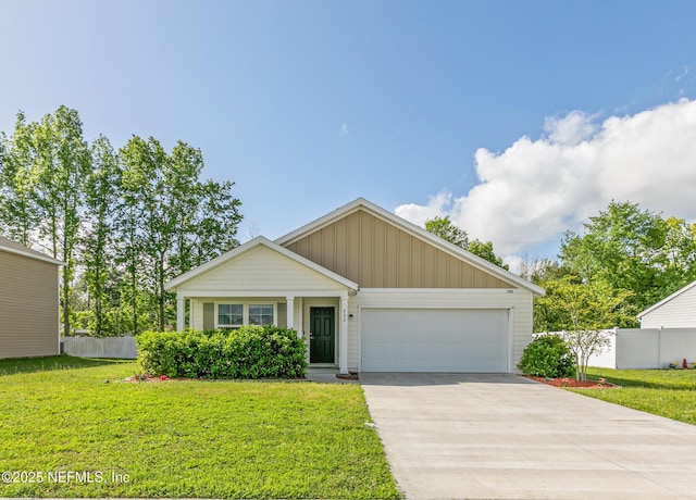 view of front of house with a garage, fence, and a front lawn