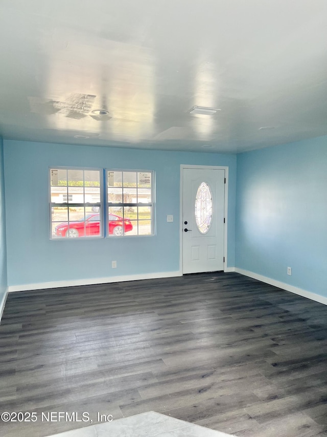 entryway with baseboards and wood finished floors