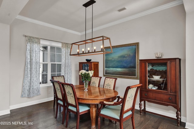 dining space with ornamental molding and dark hardwood / wood-style floors