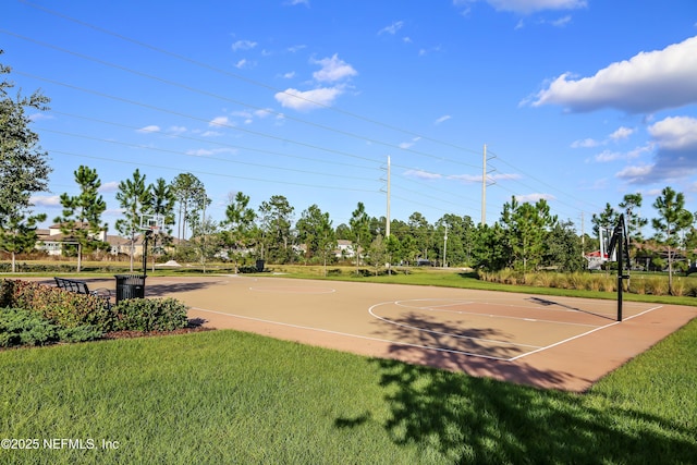 view of sport court featuring a lawn