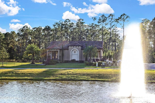 exterior space featuring a water view and a front lawn