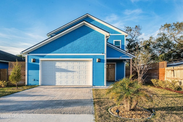 view of front facade featuring driveway, an attached garage, and fence