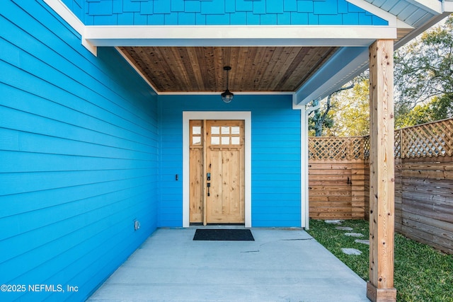 entrance to property featuring fence