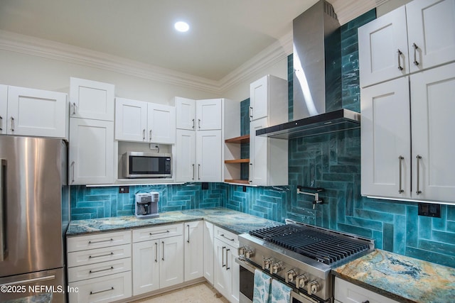 kitchen featuring wall chimney exhaust hood, stainless steel appliances, white cabinetry, and stone counters