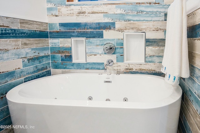 bathroom with a bathing tub and tile walls