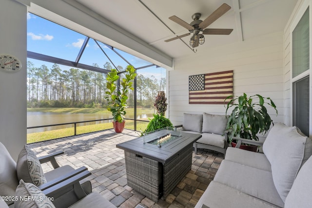 sunroom / solarium with a water view and ceiling fan