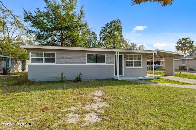 ranch-style home with a carport and a front lawn