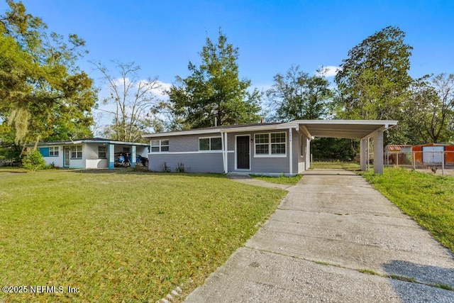 ranch-style house featuring a front yard and a carport